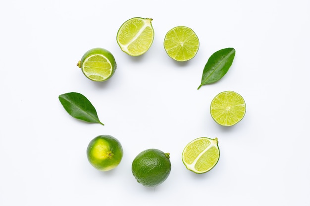 Fresh limes with leaves, rounded frame composition for background