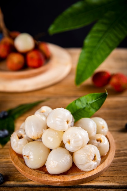 Fresh litchi fruit on wooden table