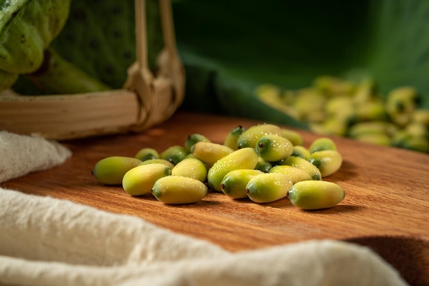 Fresh lotus seeds on a simple background