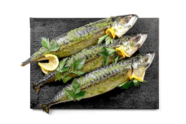 Fresh mackerel fish marinated for cooking in spices in a white plate White background selective focus