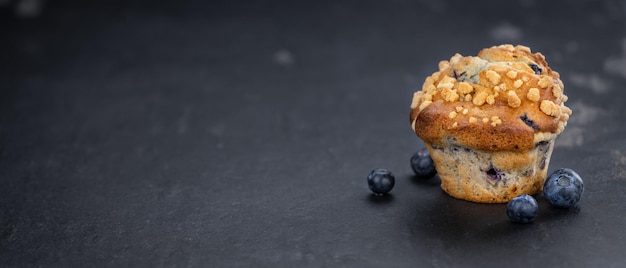 Fresh made Blueberry Muffins on a slate slab closeup shot selective focus