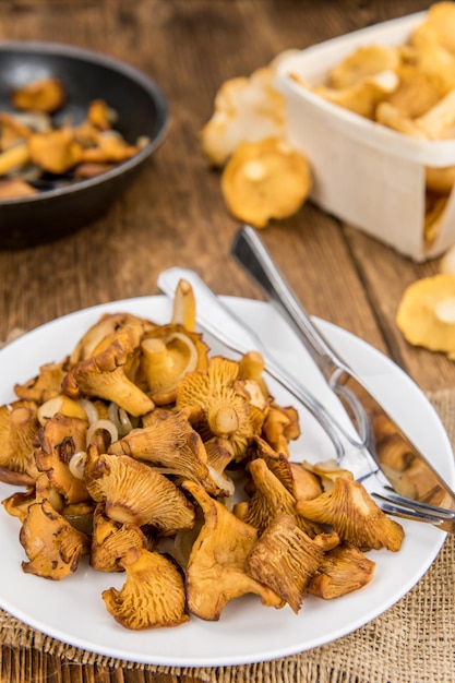 Fresh made Fried Chanterelles on a rustic background