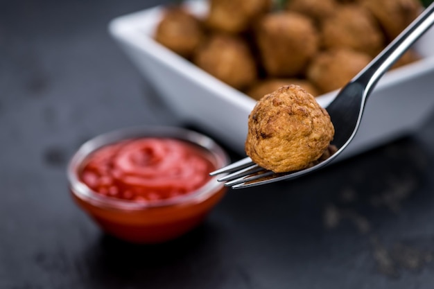 Fresh made Meatballs on a slate slab closeup shot selective focus