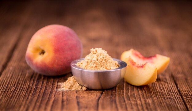 Photo fresh made peach powder on a rustic background