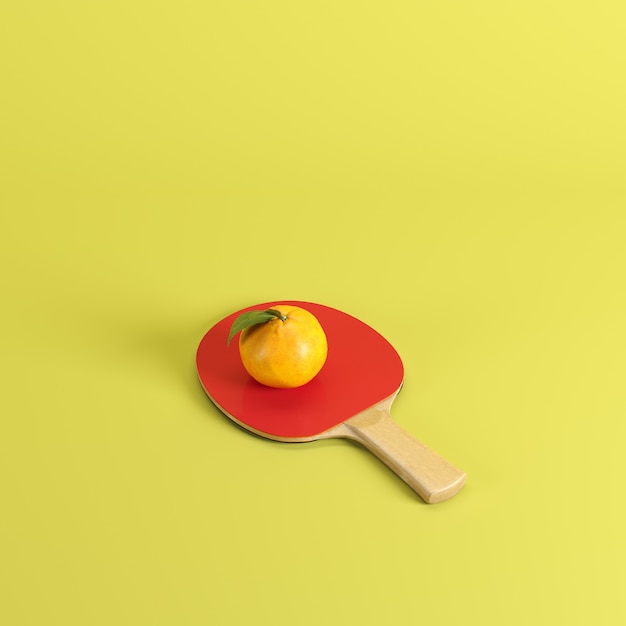 Fresh mandarin orange fruit or tangerine on ping pong paddle isolated on pastel yellow background