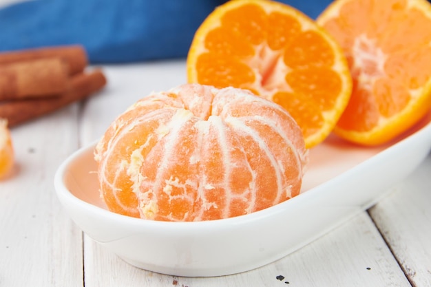 Fresh mandarin oranges fruit or tangerines with leaves on a wooden table