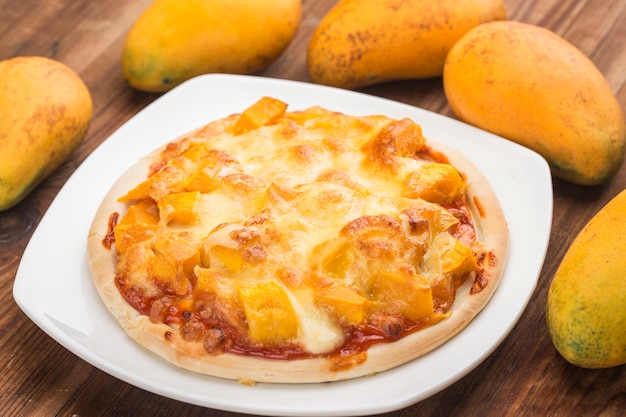 Fresh mango pizza on the table