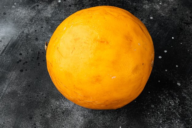 Fresh melon set, on black dark stone table background, with copy space for text