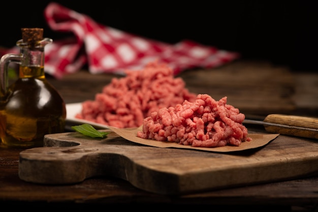 Fresh Minced Meat on vintage wooden background close up