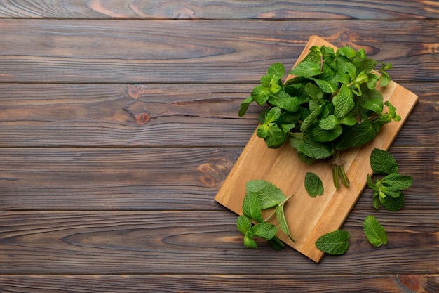 Fresh mint on Cutting board table top view Flat lay Space for text