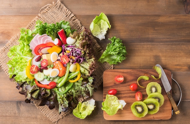 fresh mix vegetation salad on brown wood background