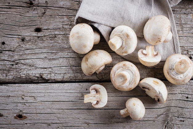 Fresh mushrooms champignons on a wooden background. Autumn Harvest Food Vegetarian Vegetab