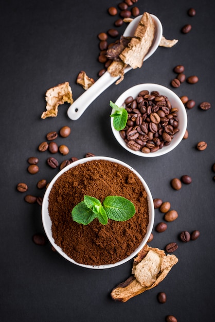 fresh mushrooms and coffee beans on dark