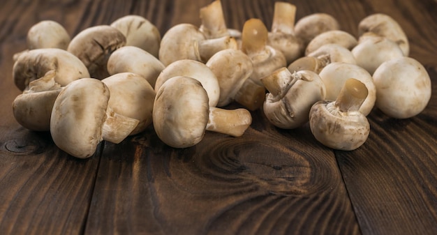 Fresh mushrooms scattered on a wooden table