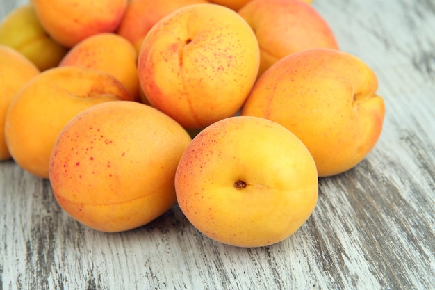 Fresh natural apricot on wooden table close up