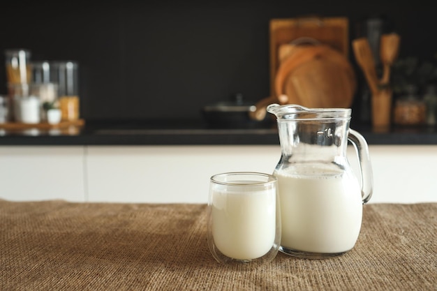 Fresh natural milk in a glass and jug at home