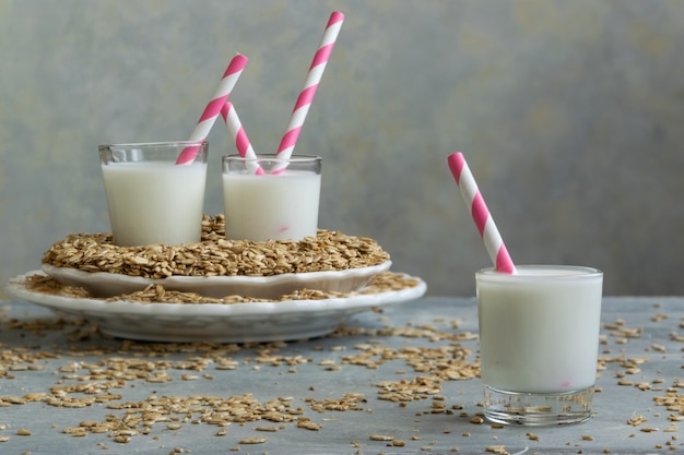 Fresh oat milk drink and oat flakes