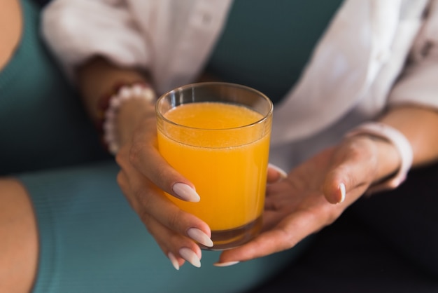 fresh ogange juice in womans hands