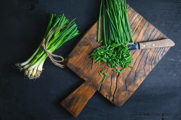 Fresh onion cut on wooden chopping board