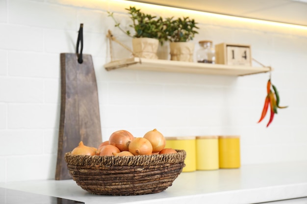 Fresh onions on countertop in modern kitchen