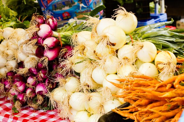 Fresh onons in a large pile at the local farmer's  market.