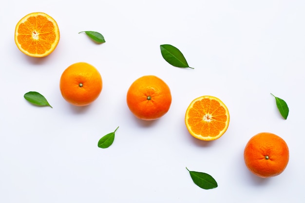 Fresh orange citrus fruits with leaves on white background.  