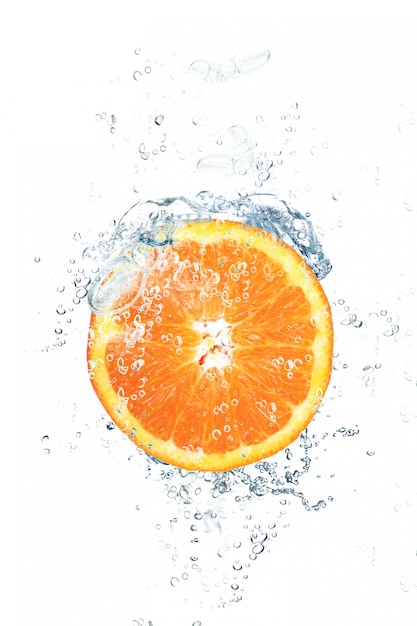 Fresh orange falling in water