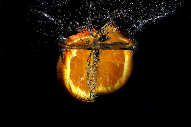 Fresh orange fell in the water