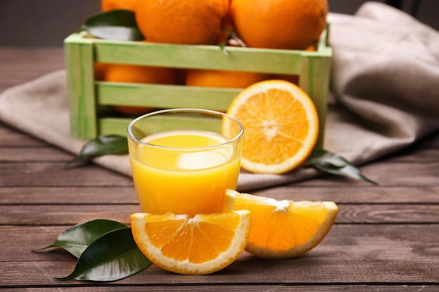 Fresh orange juice with fruits on table