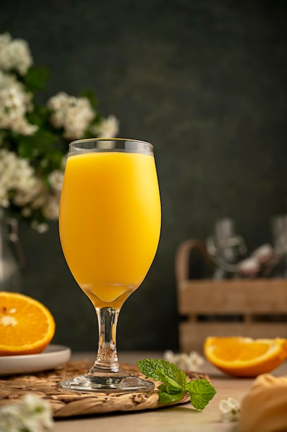 Fresh orange juice with orange fruit cocktail glass and dark moody lifestyle background Summer refreshing drink