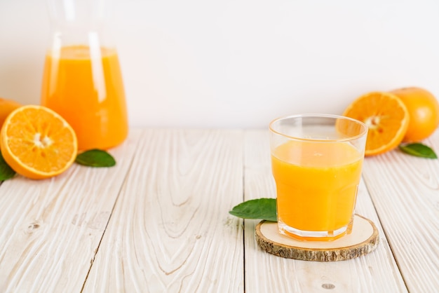 Fresh orange juice on wood background