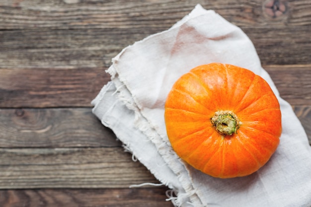 Fresh orange pumpkin on homespun napkin