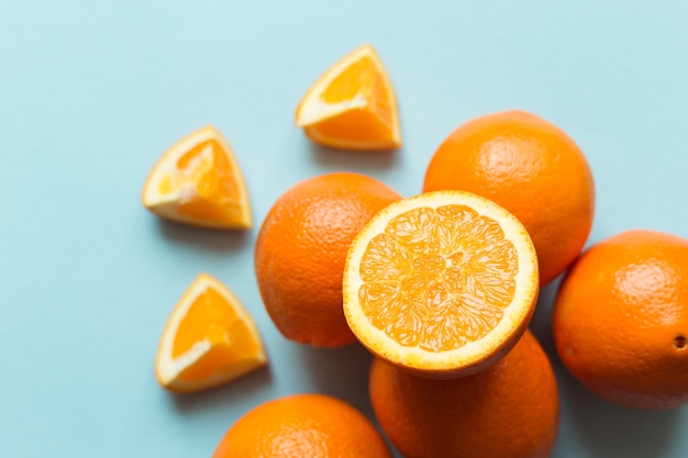 Fresh oranges on the blue surface