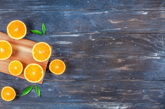 Fresh oranges on dark wooden background