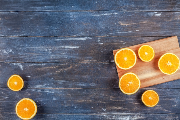 Fresh oranges on dark wooden background