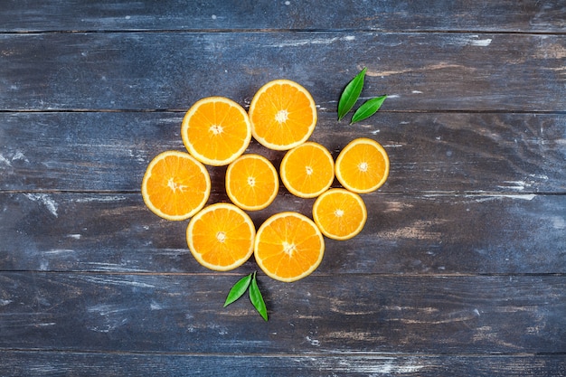 Fresh oranges on dark wooden table