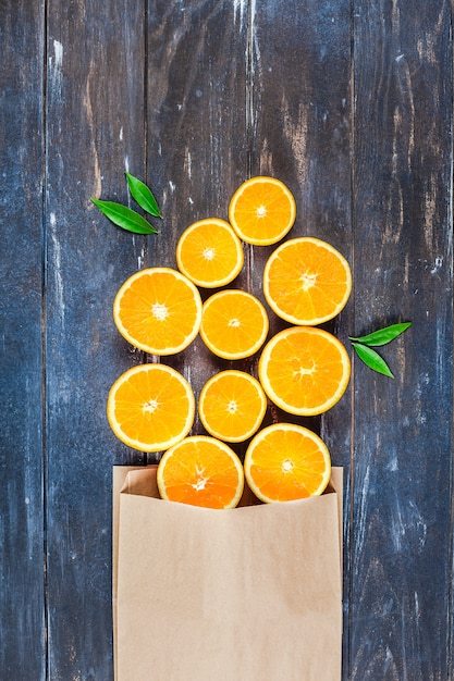 Fresh oranges on dark wooden table