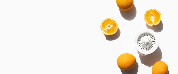 Fresh oranges prepared for juicing in a hand bowl on a white background Top view flat lay Banner