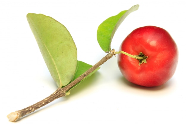 Fresh organic acerola with green leaves, isolated on white background with clipping path