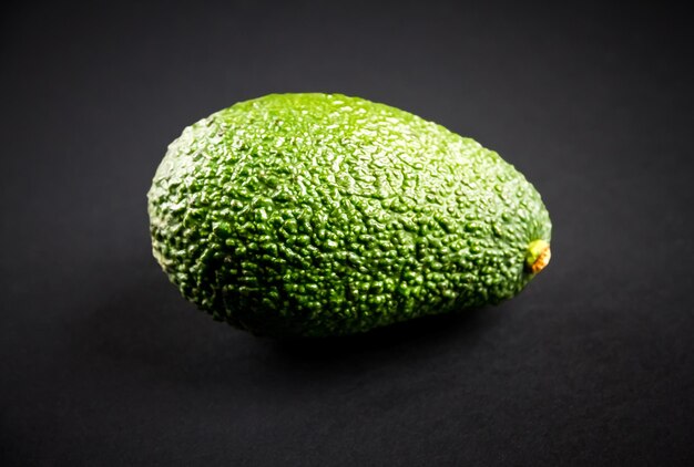 Fresh organic avocado isolated on a black background