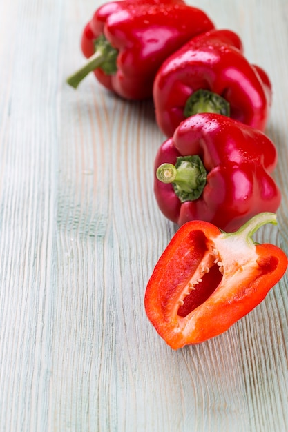 Fresh organic bell peppers on a wooden board