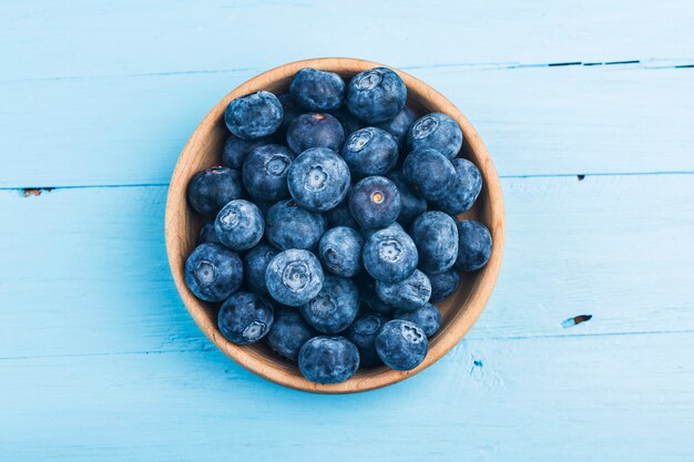 Fresh organic blueberries in wooden bowl