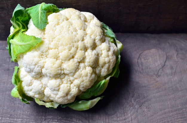 Fresh organic cauliflower vegetable on old wooden table with copy space