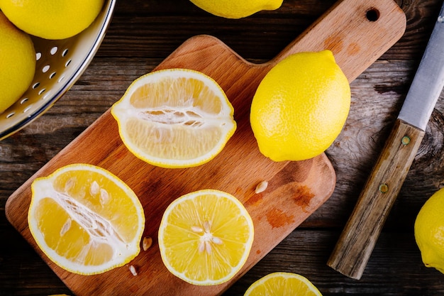 Fresh organic cut lemons on a wooden background view from above