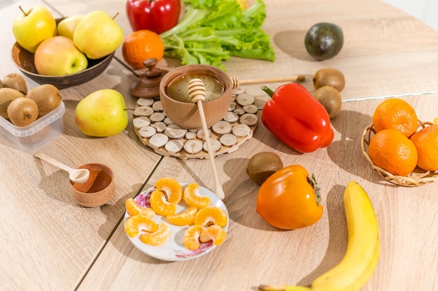 Fresh organic fruits and vegetables on wooden background.