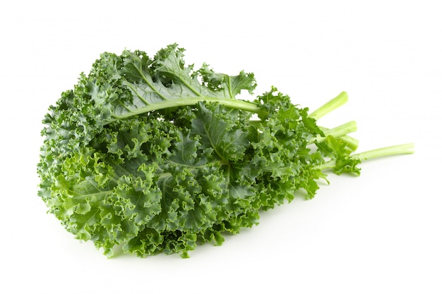 Fresh organic green kale leaves isolated over white background