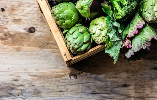 Fresh organic green vegetables in a wooden box