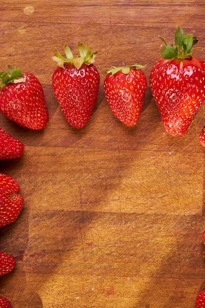 Fresh organic strawberries on a wooden cutting board