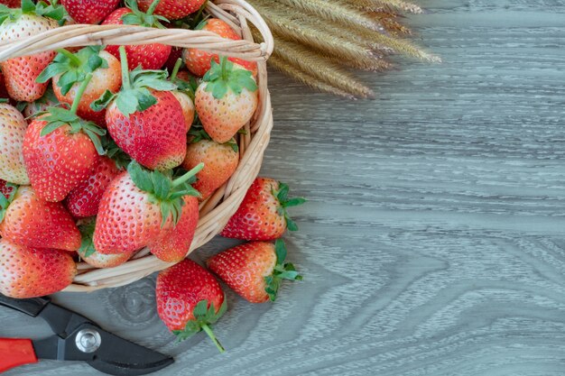 Fresh organic strawberry on basket. wooden background. 