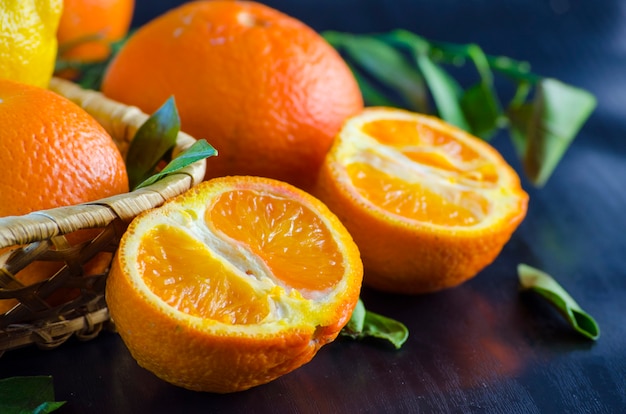 Fresh organic tangerines on a black background close-up